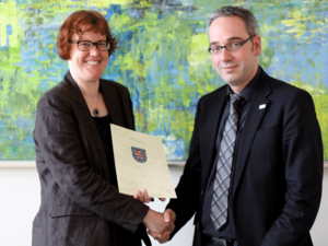 Privatdozentin Dr. phil. Dipl.-Psych. Claudia Steinbrink nahm im Juli 2014 ihre Ernennungssurkunde aus den Händen von Jan Gerken, Kanzler der Universität Erfurt, entgegen.